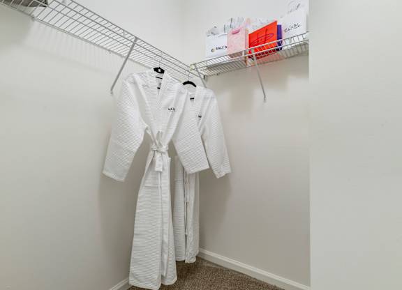 Walk-in closet with wire shelving and bathrobe at Pier Village Apartments, New Jersey, 7740