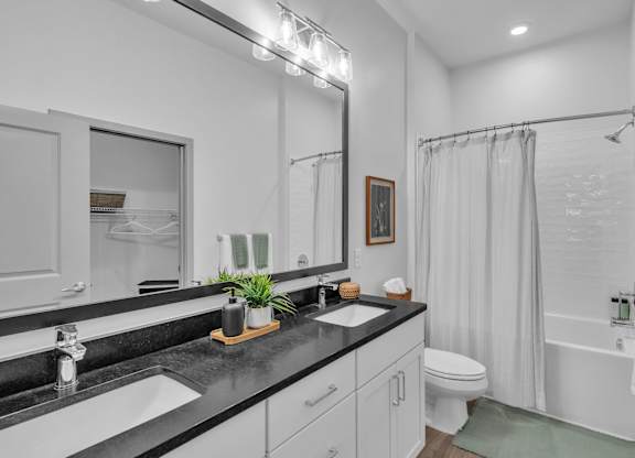 A Bathroom with White Fixtures at District 757 Apartments, Norfolk, Virginia