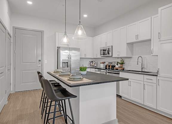 A Kitchen with Bar Stools at District 757 Apartments, Norfolk, Virginia