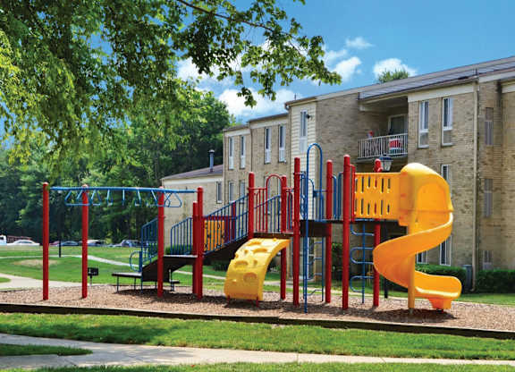 Colorful playground with spiral slide and climbing features at The at Elmwood Terrace Apartments, Maryland, 21702