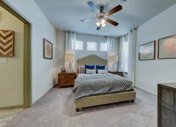 Bedroom with bed, lamps, ceiling fan and light Bedroom with bed, lamps, ceiling fan and light at Estraya Westover Hills, San Antonio, Texas