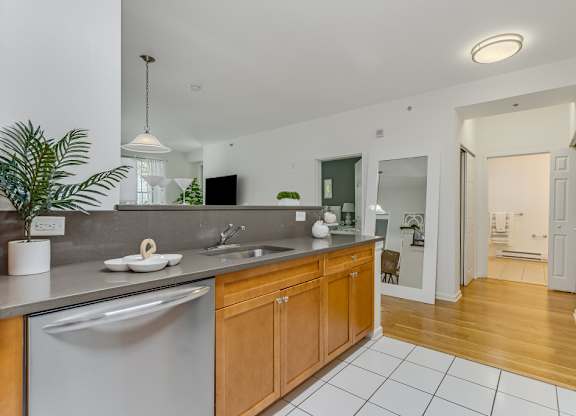 Kitchen with wood cabinets and stainless steel appliances at Pier Village Apartments, Long Branch, 7740