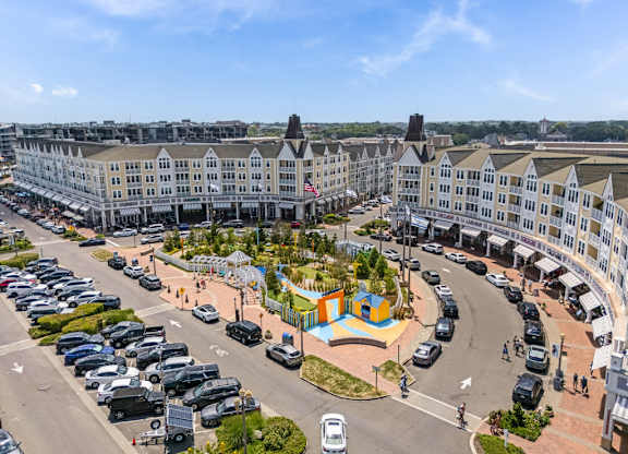 Circular plaza with colorful playground and parking areas at Pier Village Apartments, Long Branch, New Jersey