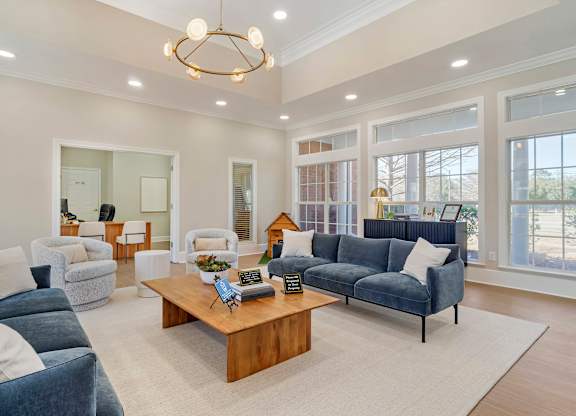 A living room with a blue couch and a wooden coffee table. at Greenbrier Estates, Slidell, 70460