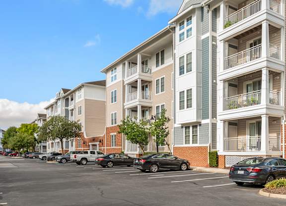A parking lot with cars and apartment buildings. at River House Apartments, Norfolk, Virginia