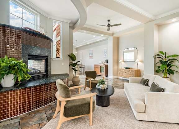 A living room with a fireplace and a couch. at River House Apartments, Norfolk, 23504