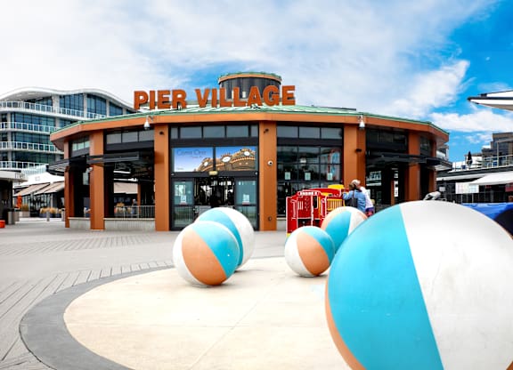 Outdoor plaza with colorful spherical play sculptures at Pier Village Apartments, Long Branch, 7740
