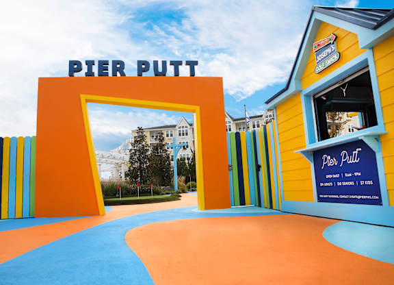 Colorful mini golf entrance with putt signage at Pier Village Apartments, Long Branch