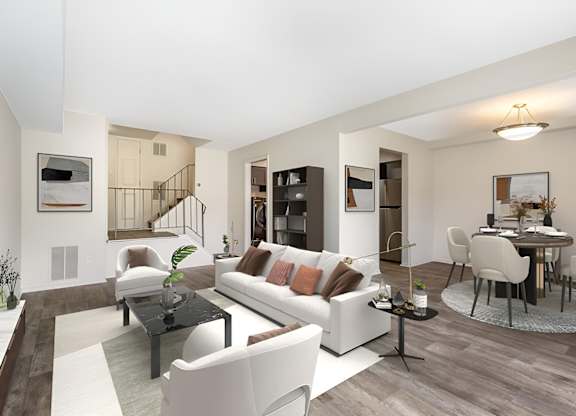 a living room with white couches and chairs and a dining room with a table and chairs at Copper and Quarry Village, Maryland