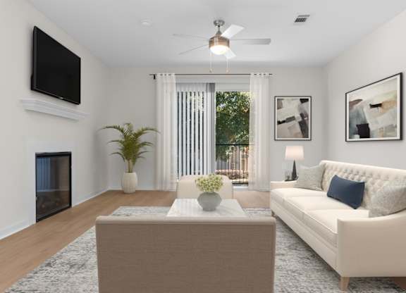 A living room with a white couch, a coffee table, a flat screen TV, and a ceiling fan. at Reflection Pointe, Flowood, 39232