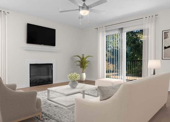 A living room with a fireplace, two chairs, a sofa, and a television. at Reflection Pointe, Mississippi