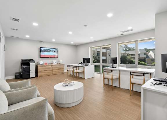 A modern office space with a flat-screen TV mounted on the wall.