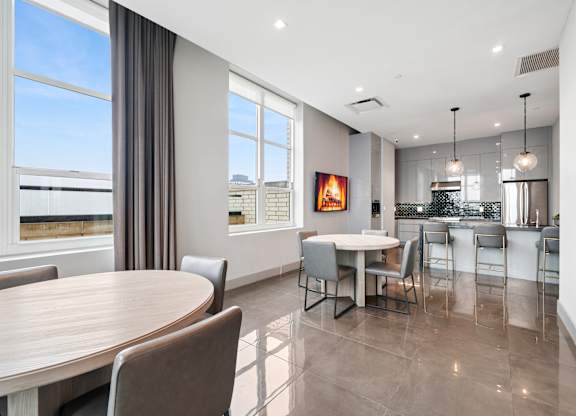 A modern dining room with a large table and chairs.