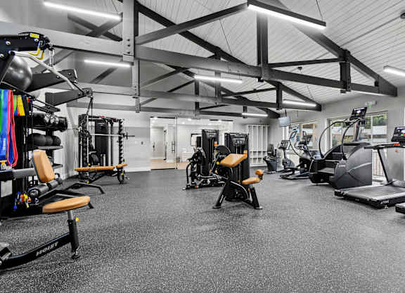 A spacious gym with various exercise equipment.