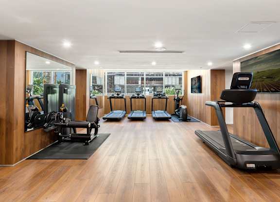 Fitness center with treadmills and strength equipment at The Hamilton Apartments, Florida
