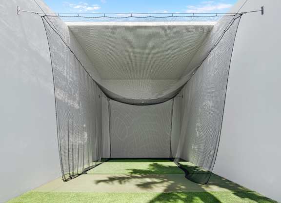 Golf practice net in outdoor enclosure at The Hamilton Apartments, Miami, FL 33137