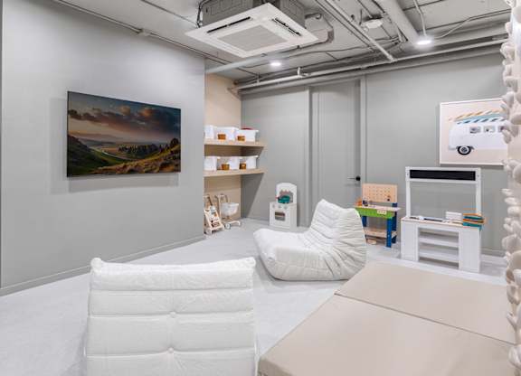 Childrens playroom with soft seating and toys at The Hamilton Apartments, Miami, FL