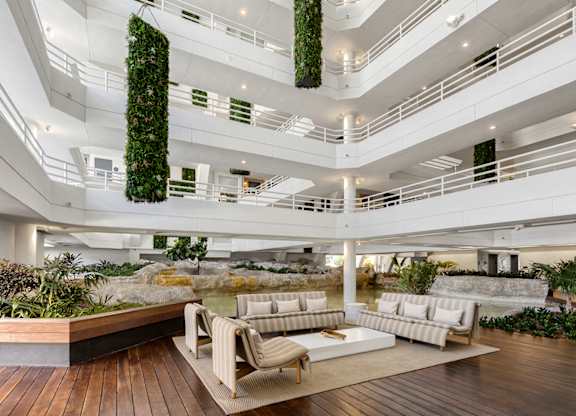 Atrium lobby with living wall and modern seating at The Hamilton Apartments, Miami