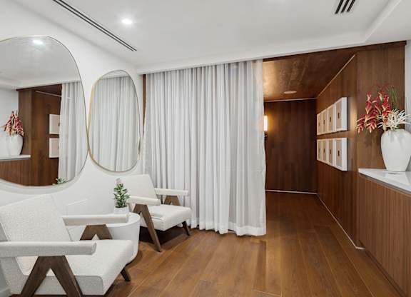 Spa relaxation room with modern chairs and mirrors at The Hamilton Apartments, Miami, FL