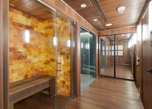 Sauna and steam room with wood paneling at The Hamilton Apartments, Miami, Florida