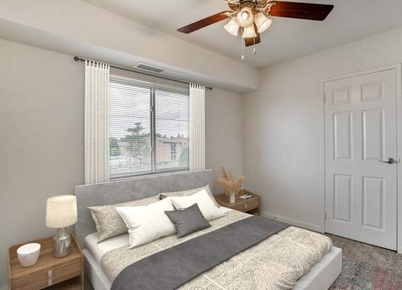 A Bedroom with Nightstand at The Manor/The Manor East Apartments, Leesburg