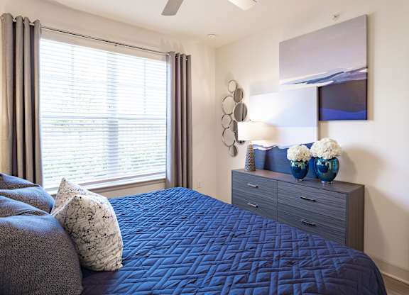 Bedroom with window at The Rosemary Apartments, Humble, Texas