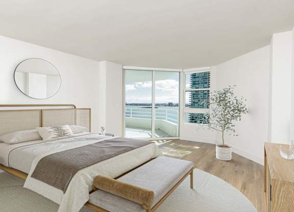 Bedroom with waterfront views and natural light at The Hamilton Apartments, Miami, FL 33137