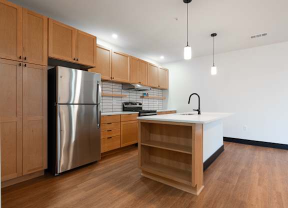 Kitchen with stainless steel refrigerator at The Yard Apartments, Louisville, 40202