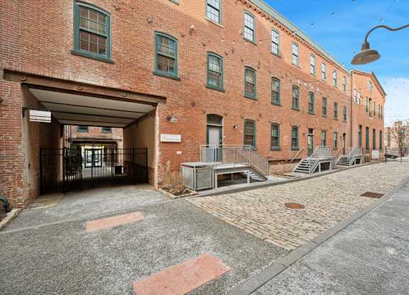 A brick building with a covered walkway in front.