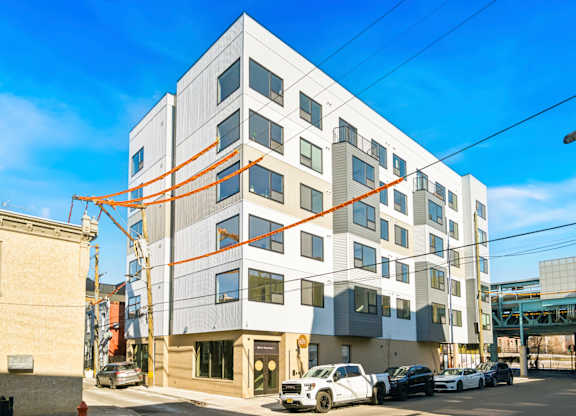 A modern white building with orange lines on the side.
