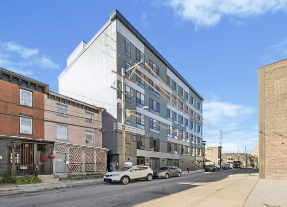 a large apartment building on a city street at The Commons On Ludlow Apartments, Philadelphia, 19104