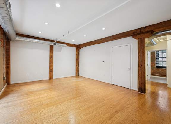 A room with wooden floors and white walls.