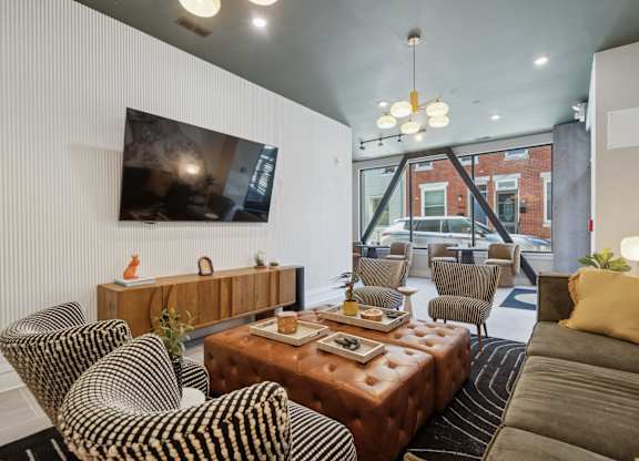 A living room with a brown leather couch and a wooden coffee table.