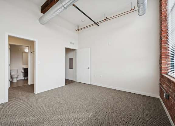 A room with a carpeted floor and white walls.