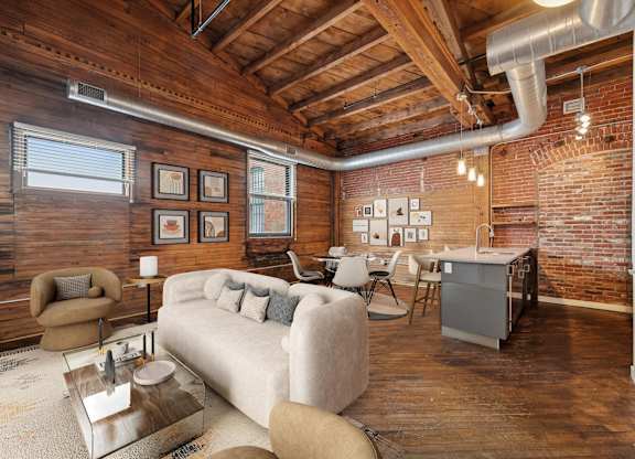 A living room with a couch, armchair, and coffee table.