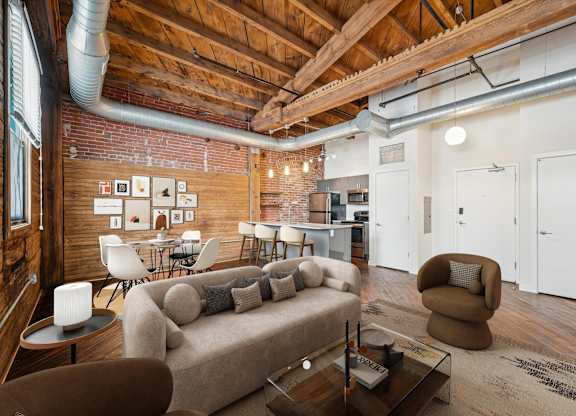 A living room with a brown couch and a coffee table.
