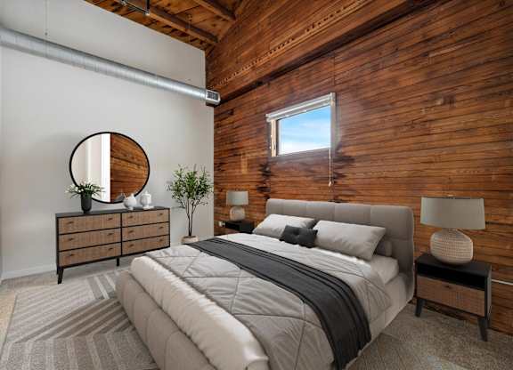 A bedroom with a large bed and a wooden wall.