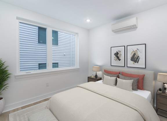 A bedroom with a large bed, two nightstands, and a window with blinds.