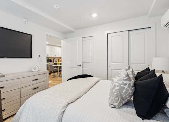 A bedroom with a large bed at The Isaac Apartments, Philadelphia, PA 19122