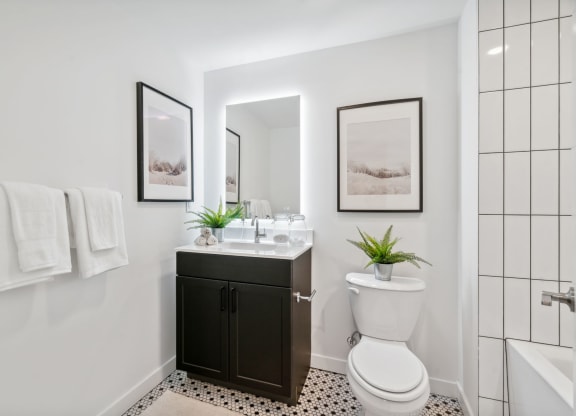 Bathroom with a toilet, sink and a tub at The Isaac, Philadelphia, PA, 19122