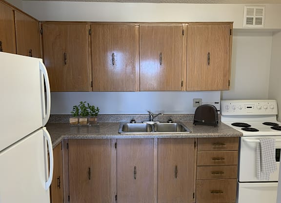 Kitchen with Wood Cabinets and White Appliances