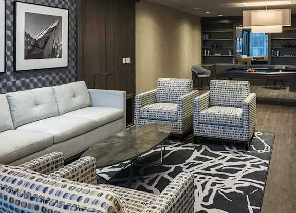 A party room with a pool table and a sofa.