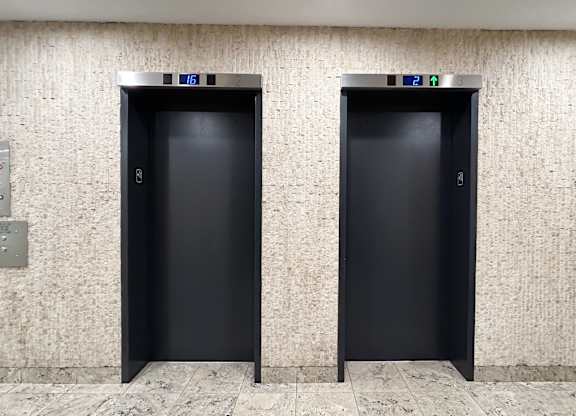 Two black doors with numbers 16 and 17 on them.