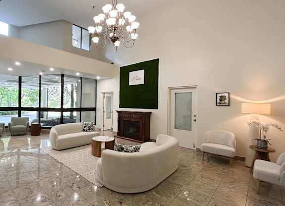 A living room with a fireplace and a chandelier.