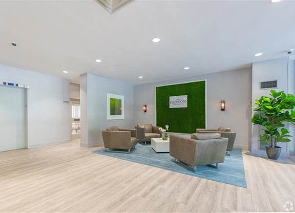 A spacious waiting area with a green wall and brown furniture.