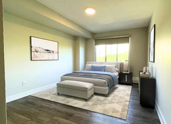 A bedroom with a bed, nightstand, and window.
