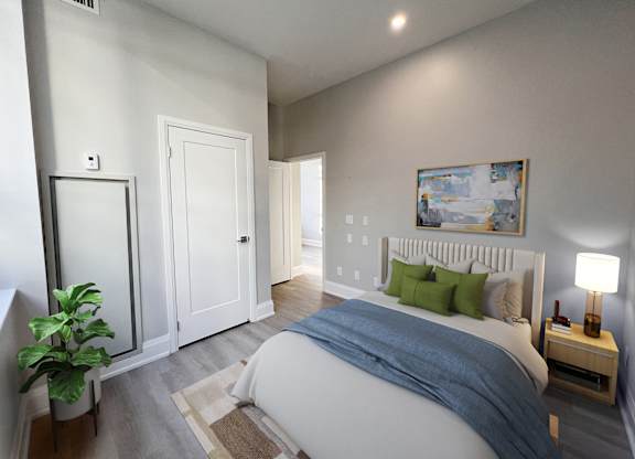 A bedroom with a bed, nightstand, and a painting on the wall.