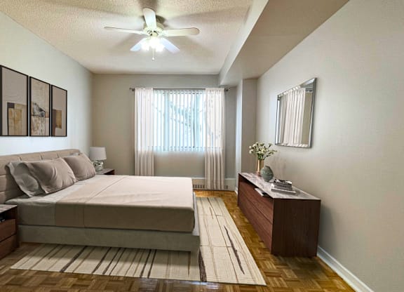 a bedroom with a bed and a ceiling fan