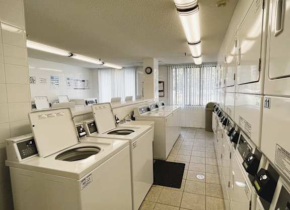 A row of washing machines in a public laundromat.