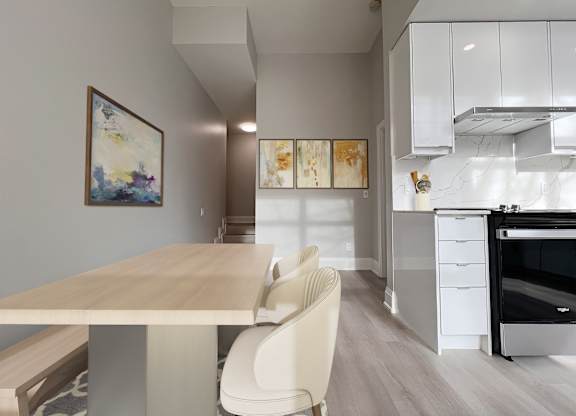 A modern kitchen with a dining table and chairs.